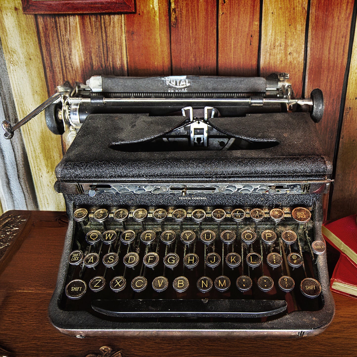 Vintage Royal Typewriter on a Desk with Vintage Books by Candlelight