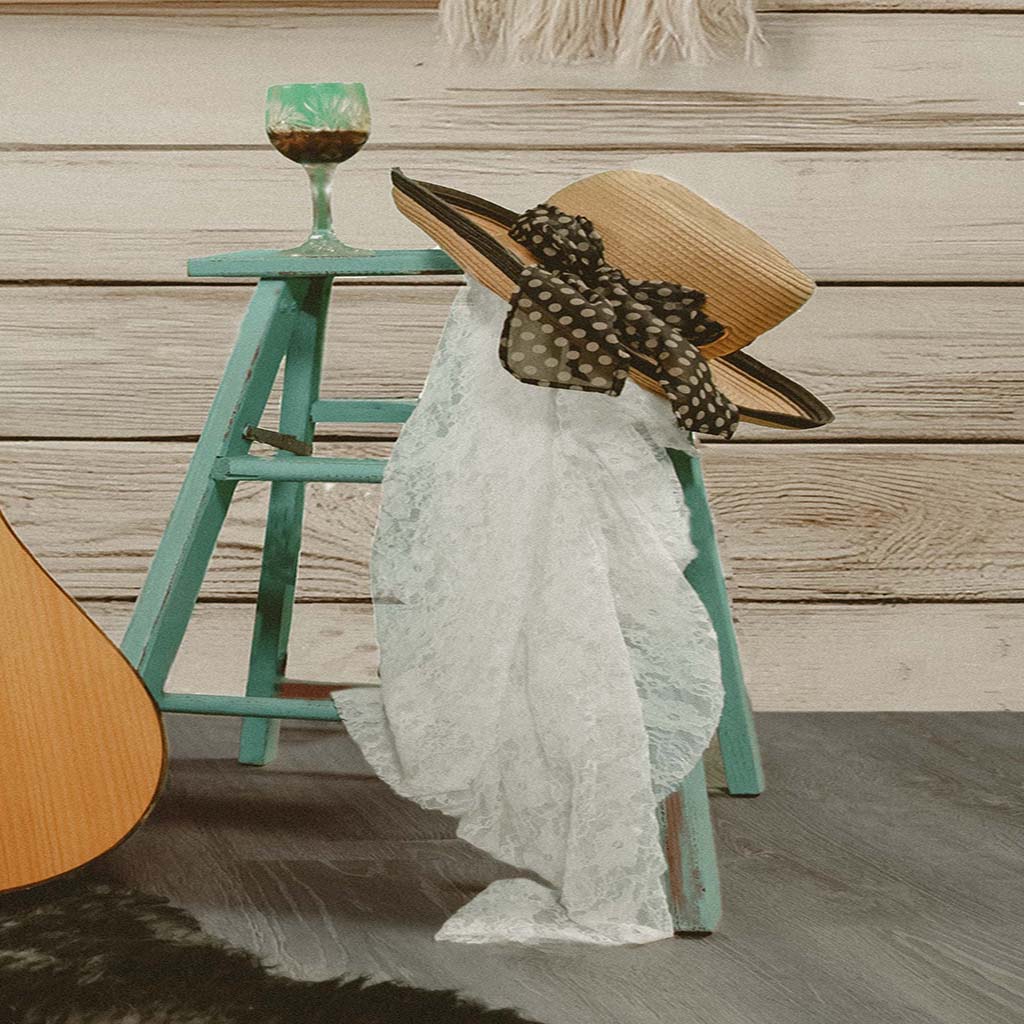 Boho Inspired Still Life with Acoustic Guitar, Wicker Chair, and Straw Hat